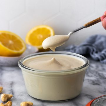 colher sendo retirada de um pote de sour cream vegano